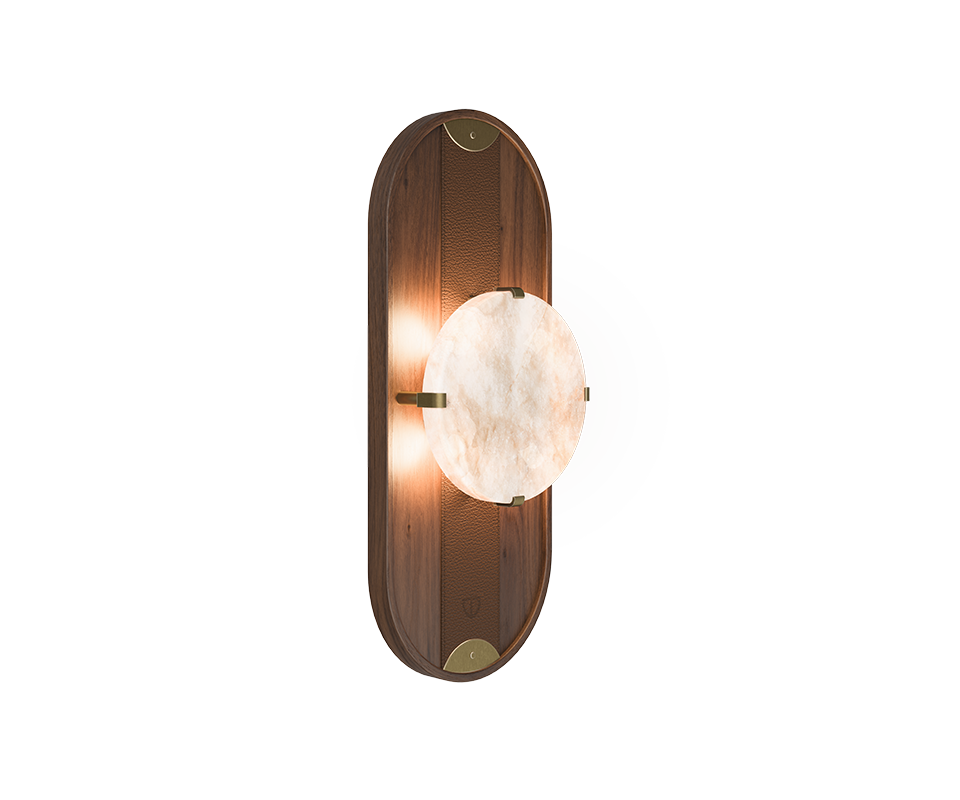 Cavendish Wall Lamp, 45º front view, with the light turned on. Crafted from smoked walnut wood and alabaster, framed in a gentle oval silhouette with aged brushed brass accents, showcasing the lamp’s refined materials and elegant design.