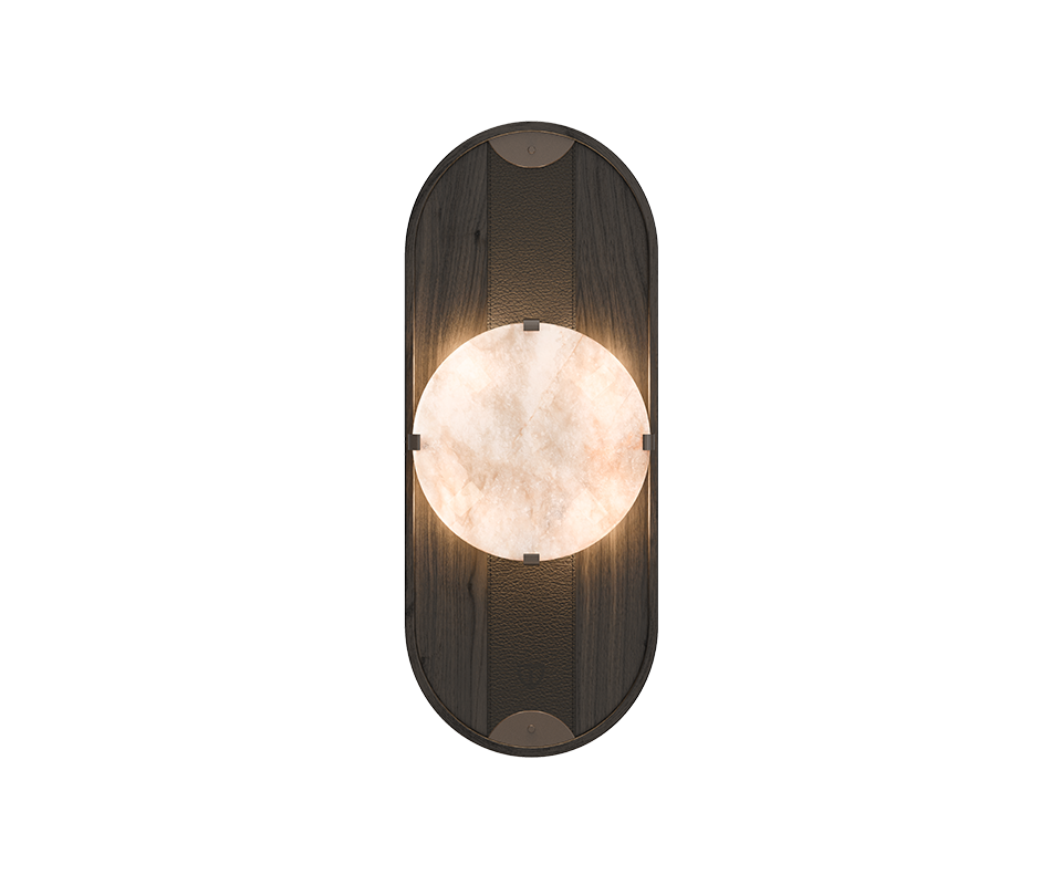 Cavendish Wall Lamp in black stained ashwood, front view, with the light turned on. Alabaster softly diffuses a warm glow through its natural veins, framed by a gentle oval silhouette with aged brushed brass accents, highlighting the refined craftsmanship and elegant materials.
