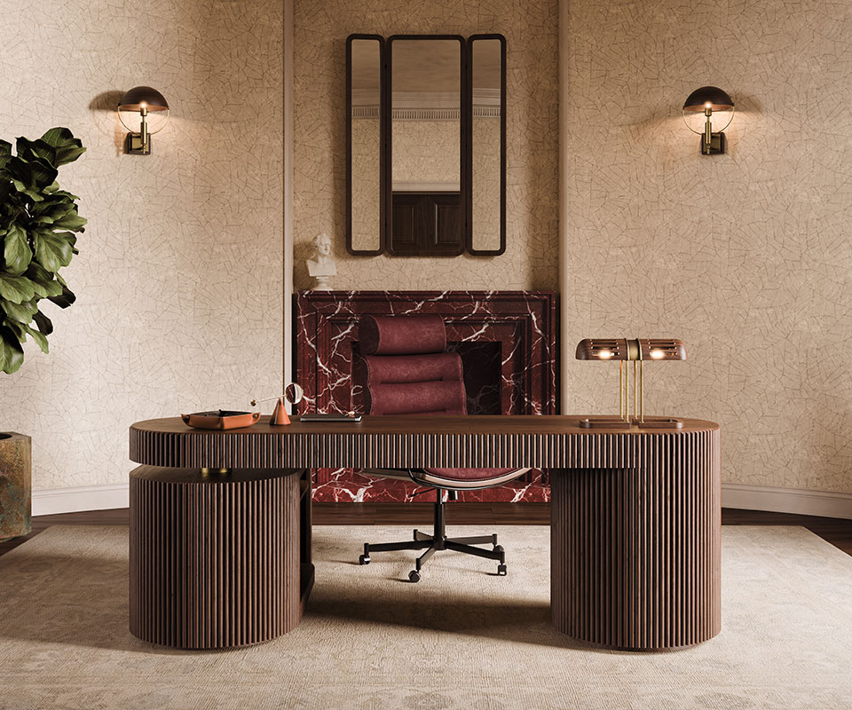 Office Edition: Home office interior featuring the Gifford desk in smoked walnut wood with a Turing table lamp on top, paired with the Thomas office chair upholstered in bordeaux leather. In the background, a marble fireplace with the Tom folding mirror above it is flanked by two illuminated Faraday wall lamps.