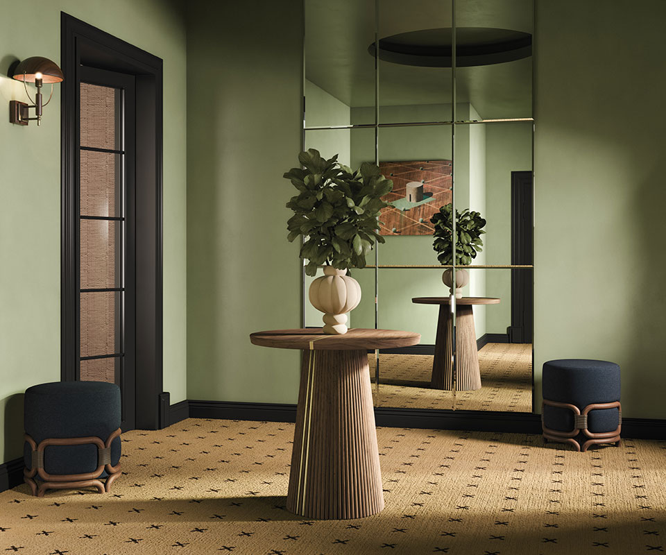 Interior design scene featuring a wall mirror, a Henry II dining table as a wooden statement piece with a decorative vase, two Stefan stools, and a Faraday wall lamp, styled in natural tones.