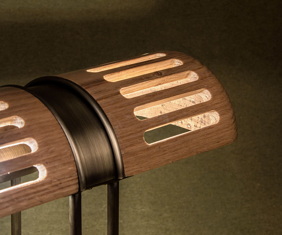 Close-up of the Turing Table Lamp shade, highlighting the aged brass details and natural oak wood grain.