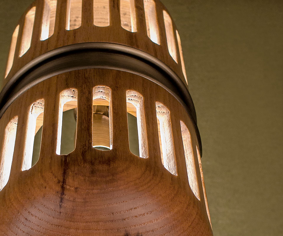 Close-up of the Turing Table Lamp shade, highlighting the aged brass details and natural oak wood grain.