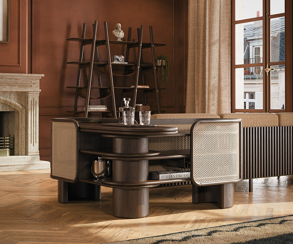 Wodehouse sideboard positioned at a 45º angle, hugging the corner of the Cownway sofa in a living room interior, paired with the Blake bookcase, with all pieces crafted in smoked walnut wood.